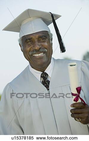 Senior Graduate holding diploma, outside, portrait View Large Photo Image Stock Photography - Senior Graduate holding diploma, outside, portrait. Fotosearch