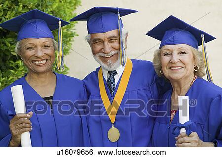 Stock Photograph - Senior graduates smiling outside, portrait. Fotosearch