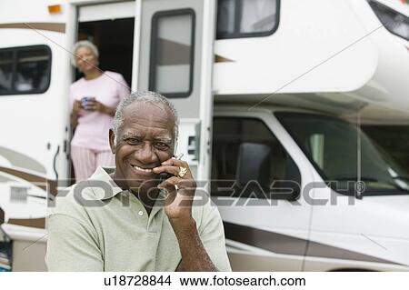 Senior man sitting in front of a caravan View Large Photo Image Picture - Senior man sitting in front of a caravan. Fotosearch