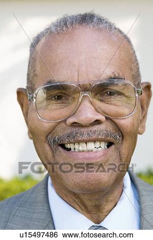 Senior Man wearing glasses and smiling, portrait, close up View Large Photo Image Stock Photograph - Senior Man wearing glasses and smiling, portrait, close up. Fotosearch