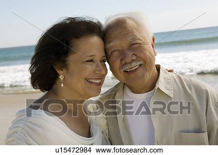 Picture - Senior Newly wed couple at beach, (close-up). Fotosearch