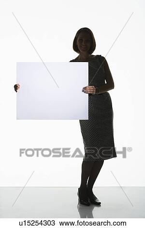 Silhouetted woman standing, holding large blank card to side View Large Photo Image Stock Image - Silhouetted woman standing, holding large blank card to side. Fotosearch