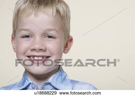 Stock Photo - Smiling blonde boy, close-up. Fotosearch