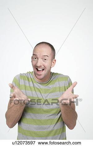Smiling Man, hands raised, Shrugging View Large Photo Image Stock Photo - Smiling Man, hands raised, Shrugging. Fotosearch