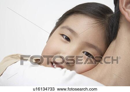 Stock Image - Smiling Young Girl on Father's Shoulders, close-up. Fotosearch