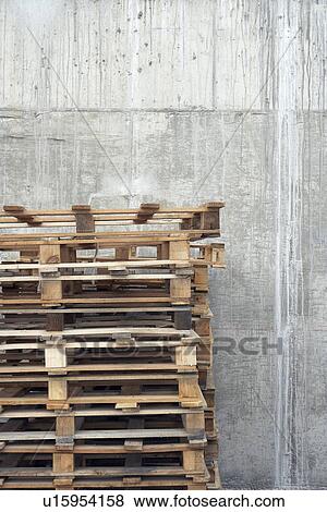 Stack of pallets against concrete wall View Large Photo Image Stock Photo - Stack of pallets against concrete wall. Fotosearch
