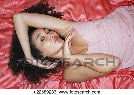 Teenage Girl Lying on pink sheets in pyjamas, posing View Large Photo Image Stock Image - Teenage Girl Lying on pink sheets in pyjamas, posing. Fotosearch