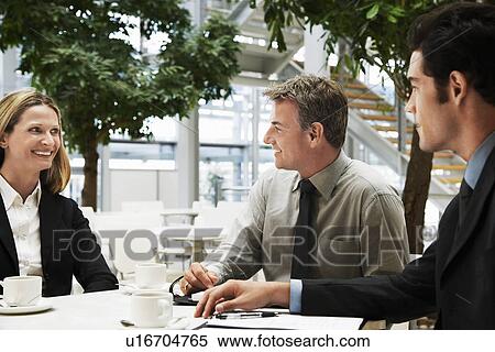 Three businesspeople in meeting, outdoors View Large Photo Image Stock Photography - Three businesspeople in meeting, outdoors. Fotosearch