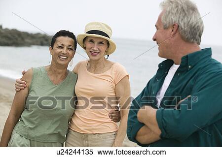 Three friends on beach View Large Photo Image Stock Photography - Three friends on beach. Fotosearch
