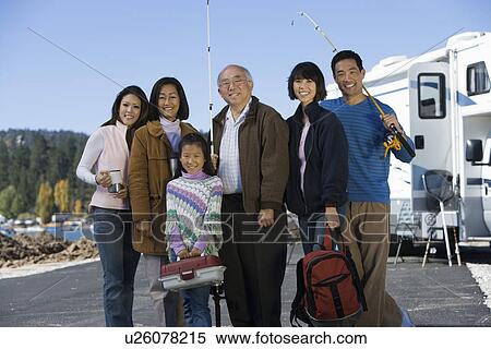 Three-generation family holding fishing poles by RV at lake View Large Photo Image Stock Photography - Three-generation family holding fishing poles by RV at lake. Fotosearch