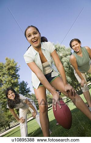 Three women playing football outdoors. View Large Photo Image Stock Photo - Three women playing football outdoors.. Fotosearch