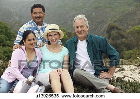Two couples at beach, (portrait) View Large Photo Image Stock Photography - Two couples at beach, (portrait). Fotosearch