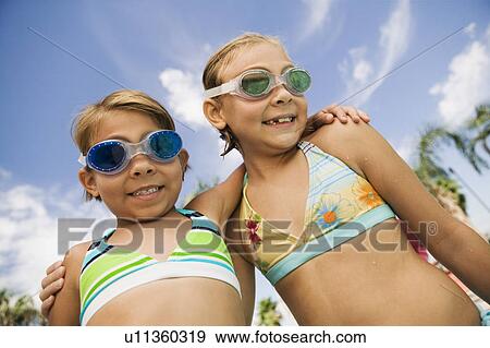 Stock Photo - Two Girls (7-9) in swimwear, portrait.. Fotosearch