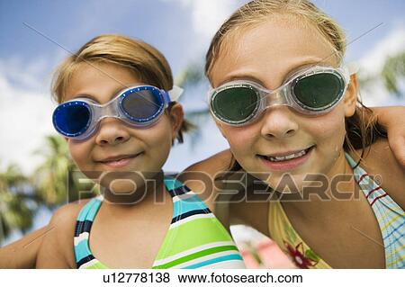 Two girls (7-9) wearing swim goggles, portrait. View Large Photo Image Stock Photo - Two girls (7-9) wearing swim goggles, portrait.. Fotosearch