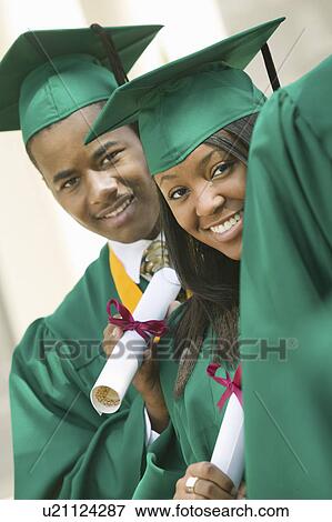 Two graduates with diplomas outside View Large Photo Image Stock Photo - Two graduates with diplomas outside. Fotosearch
