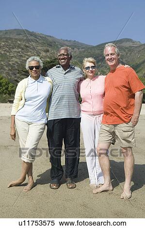 Two mature couples embracing View Large Photo Image Stock Photography - Two mature couples embracing. Fotosearch