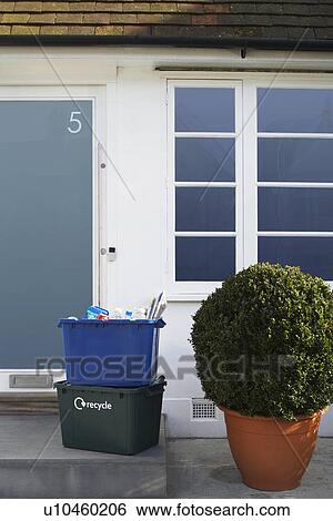 Stock Photograph - Two recycling containers outside building. Fotosearch