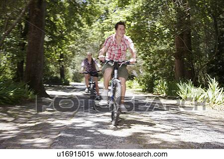 Two teenage boys (16-17 years) bicycling in forest, motion blur View Large Photo Image Stock Photography - Two teenage boys (16-17 years) bicycling in forest, motion blur. Fotosearch