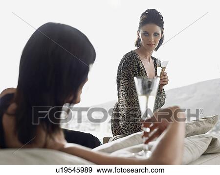 Two women drinking champagne near mountains View Large Photo Image Stock Photo - Two women drinking champagne near mountains. Fotosearch