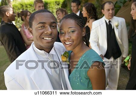 Well-dressed teenage couple standing outside school dance View Large Photo Image Stock Image - Well-dressed teenage couple standing outside school dance. Fotosearch