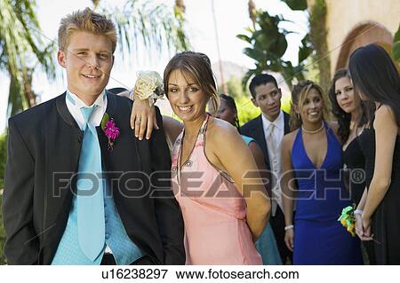 Stock Photo - Well-dressed teenage couple standing outside school dance. Fotosearch