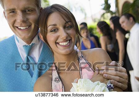Stock Photograph - Well-dressed teenage couple standing outside school dance. Fotosearch