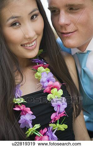 Well-dressed teenage couple wearing leis outside school dance View Large Photo Image Stock Photo - Well-dressed teenage couple wearing leis outside school dance. Fotosearch