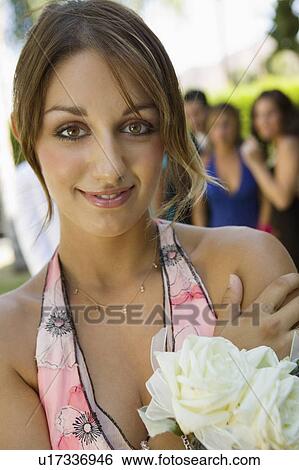 Stock Photograph - Well-dressed teenage girl outside school dance, portrait. Fotosearch