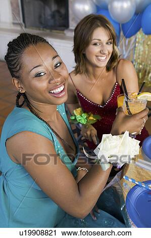 Well-dressed teenage girls drinking at school dance, elevated view View Large Photo Image Stock Image - Well-dressed teenage girls drinking at school dance, elevated view. Fotosearch