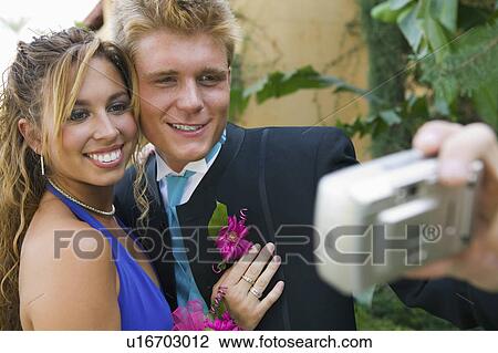Well-dressed teenager couple taking picture outside school dance View Large Photo Image Stock Image - Well-dressed teenager couple taking picture outside school dance. Fotosearch