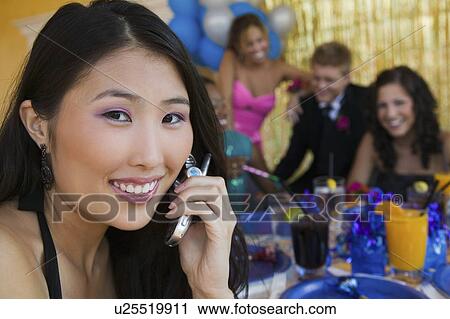 Well-dressed teenager girl using cell phone at school dance View Large Photo Image Stock Image - Well-dressed teenager girl using cell phone at school dance. Fotosearch