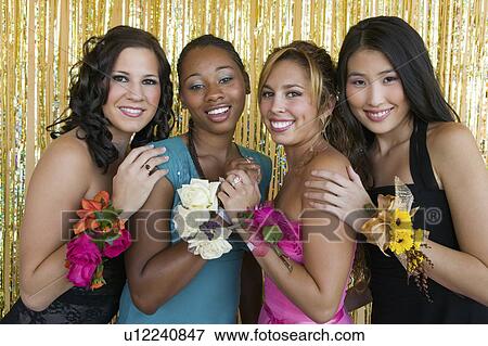 Stock Photo - Well-dressed teenager girls at school dance, portrait. Fotosearch