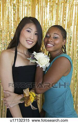 Well-dressed teenager girls hugging at school dance, portrait View Large Photo Image Stock Photography - Well-dressed teenager girls hugging at school dance, portrait. Fotosearch