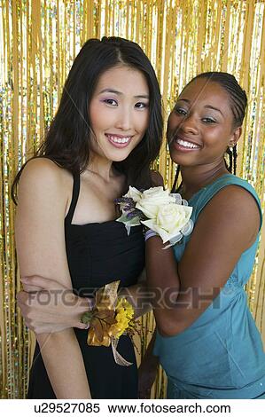 Well-dressed teenager girls hugging at school dance, portrait View Large Photo Image Stock Photography - Well-dressed teenager girls hugging at school dance, portrait. Fotosearch