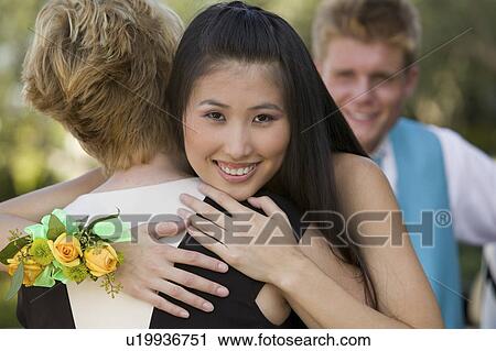 Well-dressed teenagers hugging outside View Large Photo Image Stock Image - Well-dressed teenagers hugging outside. Fotosearch
