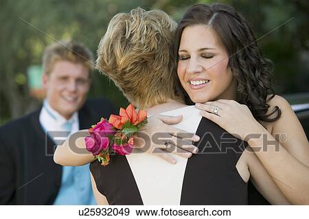 Well-dressed teenagers hugging outside View Large Photo Image Stock Photo - Well-dressed teenagers hugging outside. Fotosearch