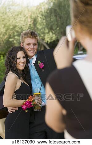Stock Image - Well-dressed teenagers taking picture outside. Fotosearch