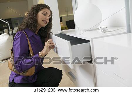 Woman Examining White Dresser drawer in furniture store, close up View Large Photo Image Stock Image - Woman Examining White Dresser drawer in furniture store, close up. Fotosearch
