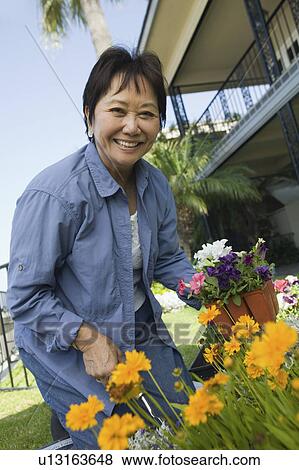 Woman gardening, (portrait) View Large Photo Image Stock Photo - Woman gardening, (portrait). Fotosearch