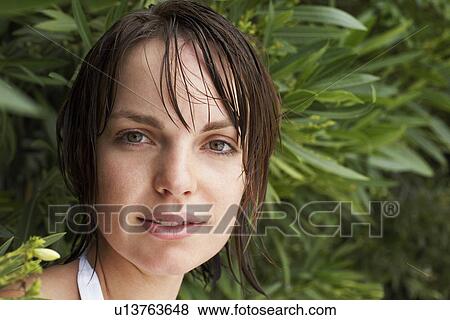Woman in lush foliage, close-up, portrait View Large Photo Image Stock Photo - Woman in lush foliage, close-up, portrait. Fotosearch
