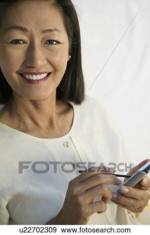 Woman using PDA, portrait View Large Photo Image Stock Photo - Woman using PDA, portrait. Fotosearch