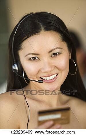 Woman with Headset and Credit Card, portrait View Large Photo Image Stock Photo - Woman with Headset and Credit Card, portrait. Fotosearch