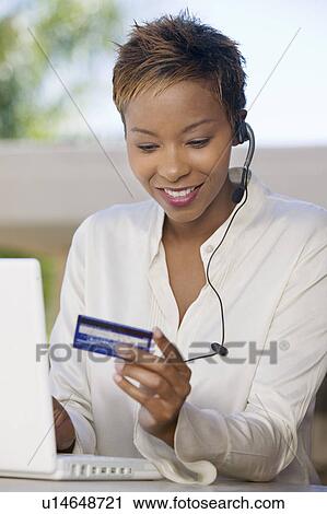 Woman with laptop on patio Using Credit Card to make online purchase View Large Photo Image Stock Image - Woman with laptop on patio Using Credit Card to make online purchase. Fotosearch