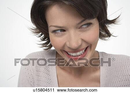 Woman with large smile, looking away, close-up View Large Photo Image Stock Image - Woman with large smile, looking away, close-up. Fotosearch