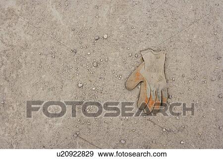 Work glove lying in the dirt View Large Photo Image Stock Photo - Work glove lying in the dirt. Fotosearch