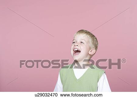Stock Image - Young boy wearing vest, shouting. Fotosearch