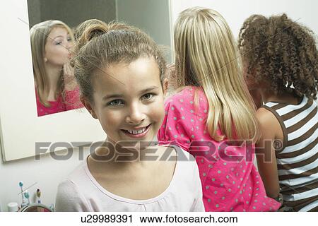 Young girl in bathroom with friends View Large Photo Image Stock Image - Young girl in bathroom with friends. Fotosearch