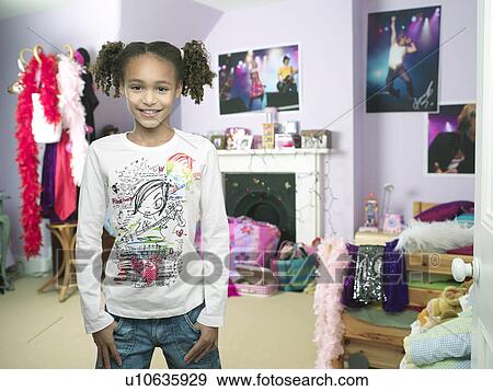 Young Girl standing, hands in pocket in bedroom View Large Photo Image Stock Photo - Young Girl standing, hands in pocket in bedroom. Fotosearch