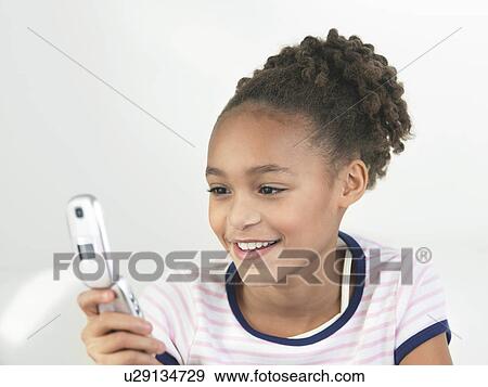 Young Girl using Cell Phone View Large Photo Image Stock Photo - Young Girl using Cell Phone. Fotosearch