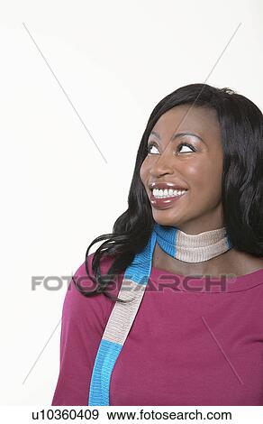 Stock Photo - Young, smiling Woman wearing scarf, looking away. Fotosearch